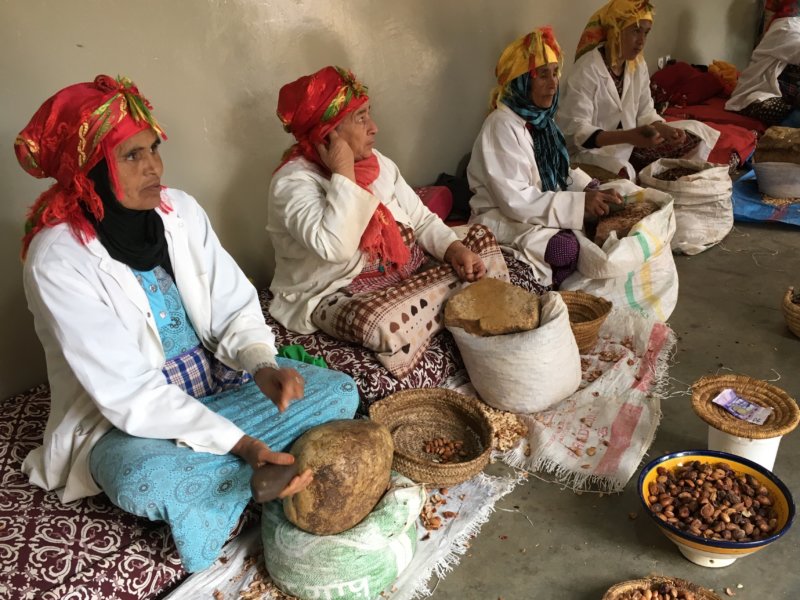 Moroccan women grinding argan seeds Moroccan women grinding argan seeds