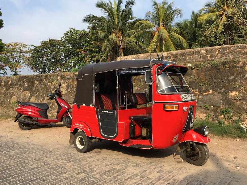 Red vehicles agains city wall, Galle Red vehicles agains city wall, Galle
