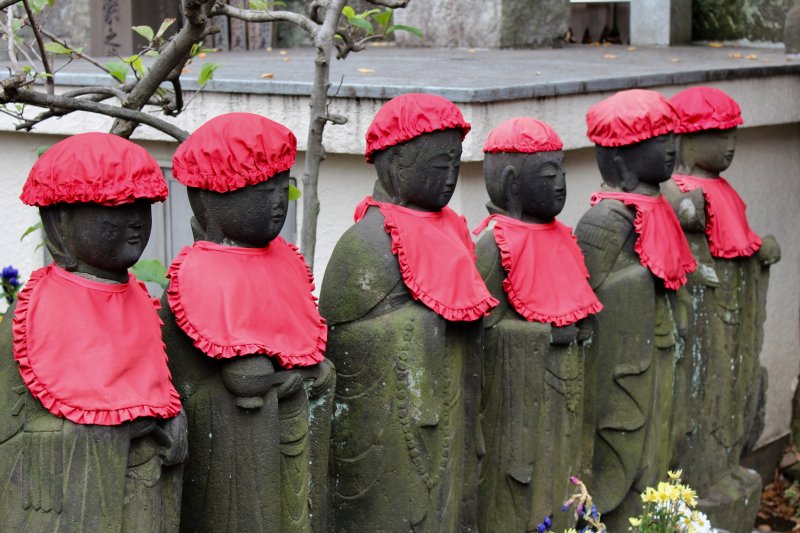 Japanese Ojizosama statues with hats and bibs Japanese Ojizosama statues with hats and bibs