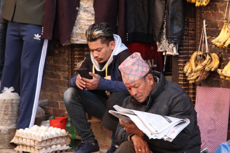 Father and son: consuming old and new media Old and modern meet in Bhaktapur