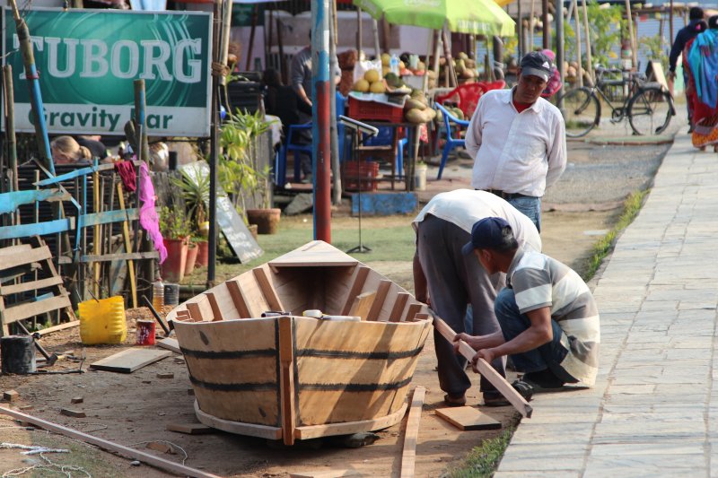 Building a wooden boat on the promenade Building a wooden boat
