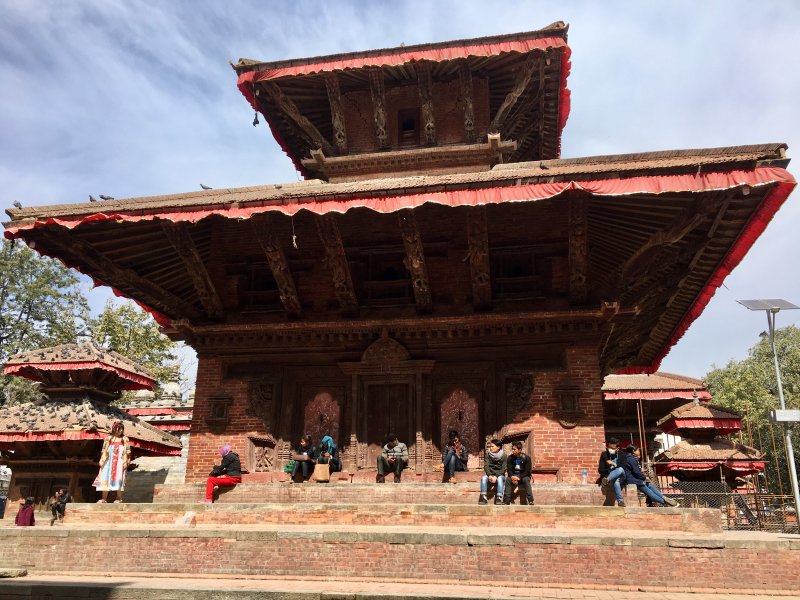 Locals sitting on temple stairs Kathmandu Durbar Square