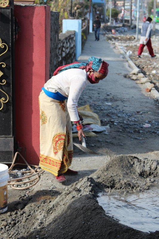 Woman working on her house gate Pokhara womat at work