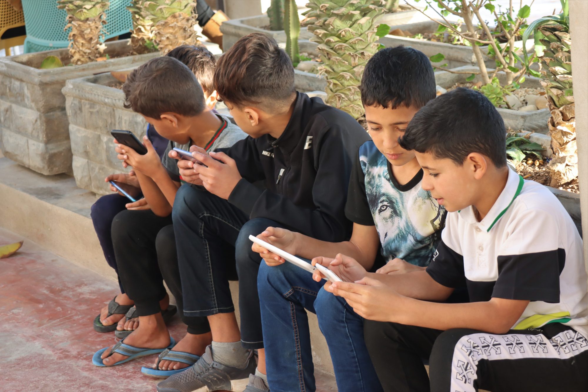 Moroccan boys with their mobile phones Moroccan boys with their mobile phones