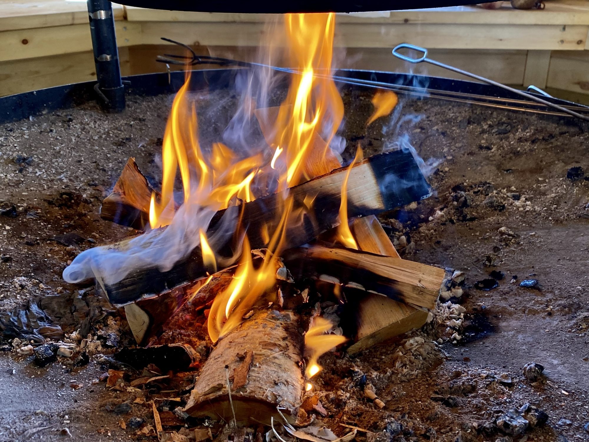 Arctic Lapland spring: campfire in a wilderness hut